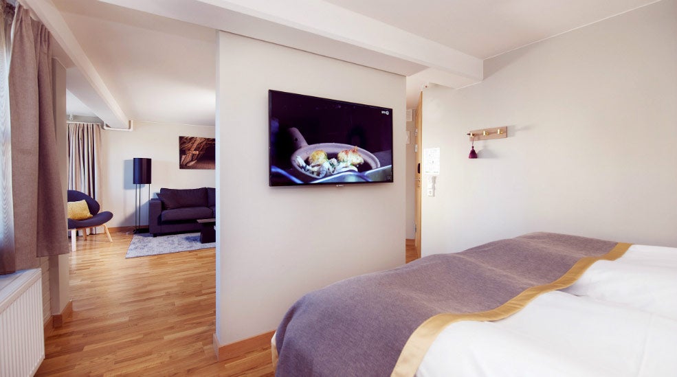 Double bed and TV in Deluxe room at Clarion Collection Hotel Bryggeparken
