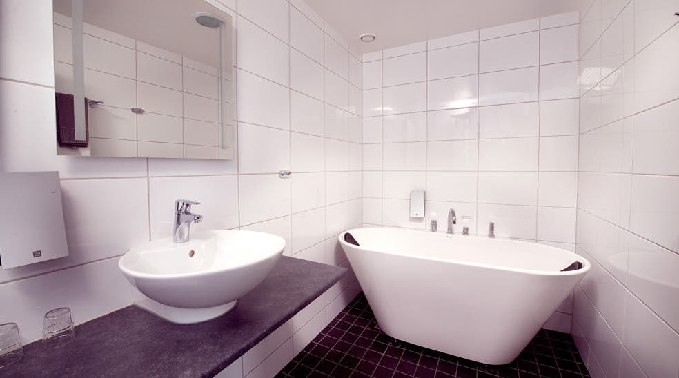 Suite with large bathroom and bathtub at Bilan Hotel in Karlstad
