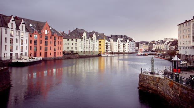 The beautiful facade of the Bryggen Hotel in Alesund by the water