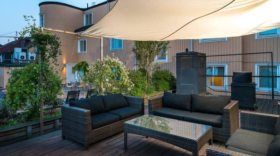 Outside terrace with seating area and roof cover at Clarion Collection Hotel Cardinal Vaxjo