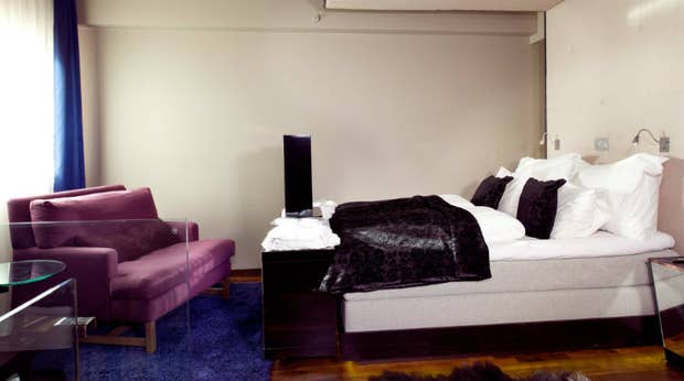 Stylish signature bedroom suite at Folketeateret Hotel in Oslo