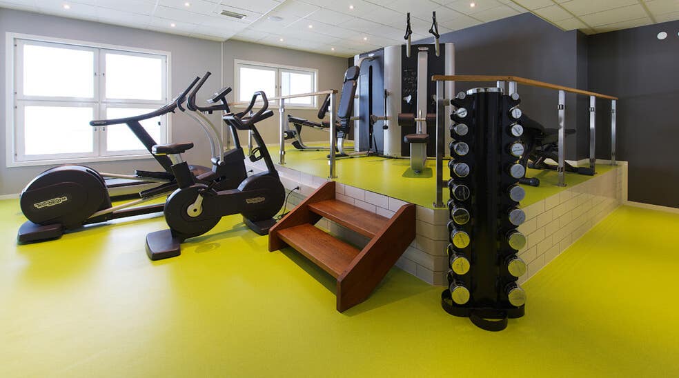 Well-equipped gym with modern fitness machines at Plaza Hotel in Karlstad
