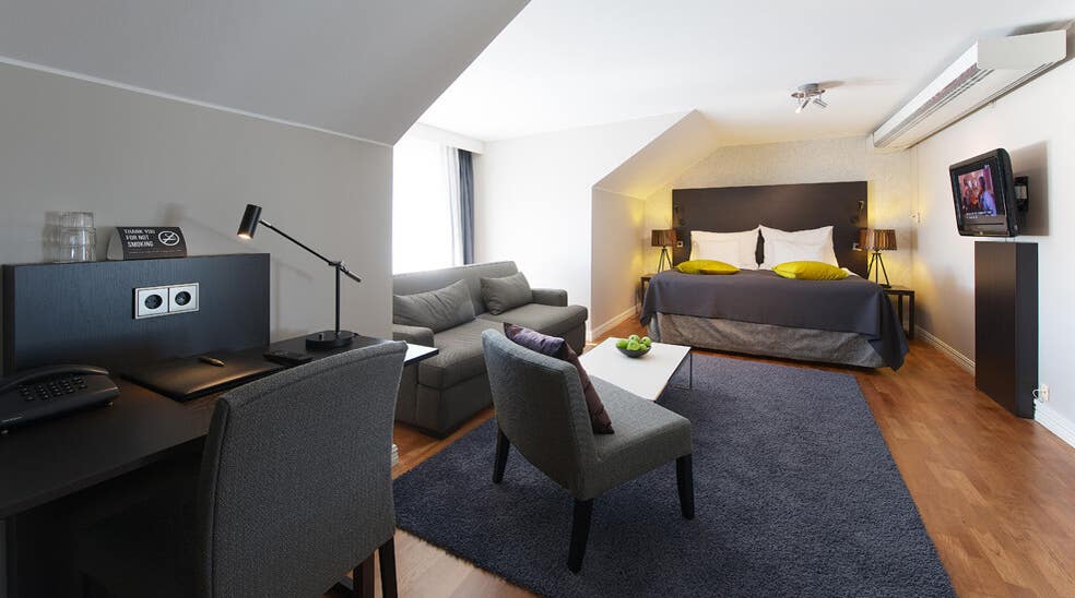 Extensive and well-furnished deluxe hotel room at Plaza Hotel in Karlstad