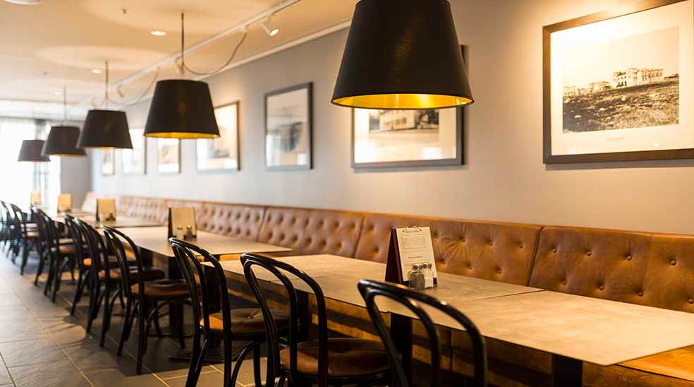 Restaurant with seating area with menu and lamps at Clarion Collection Hotel Uman Umeå