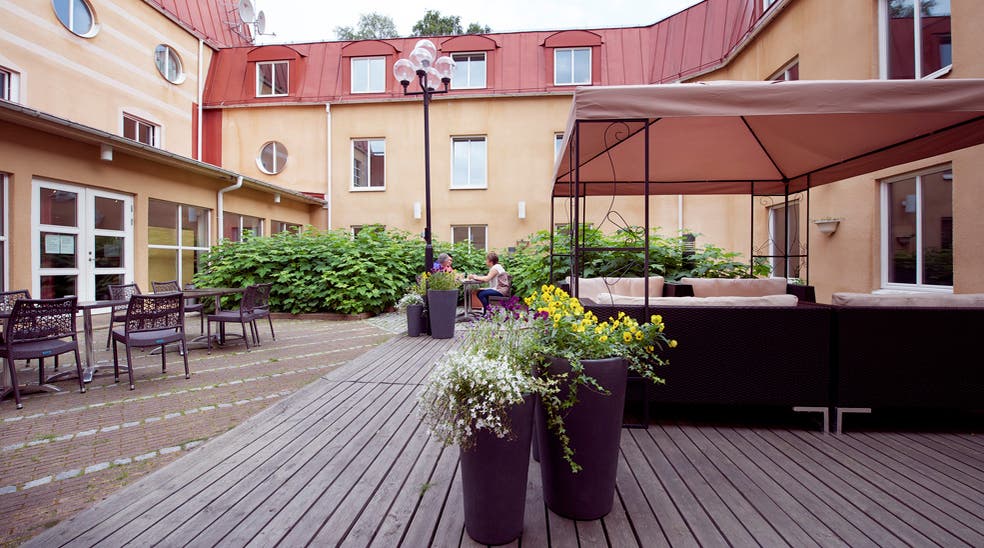 Spacious and open outdoor area with covered lounge at Uman Hotel in Umea