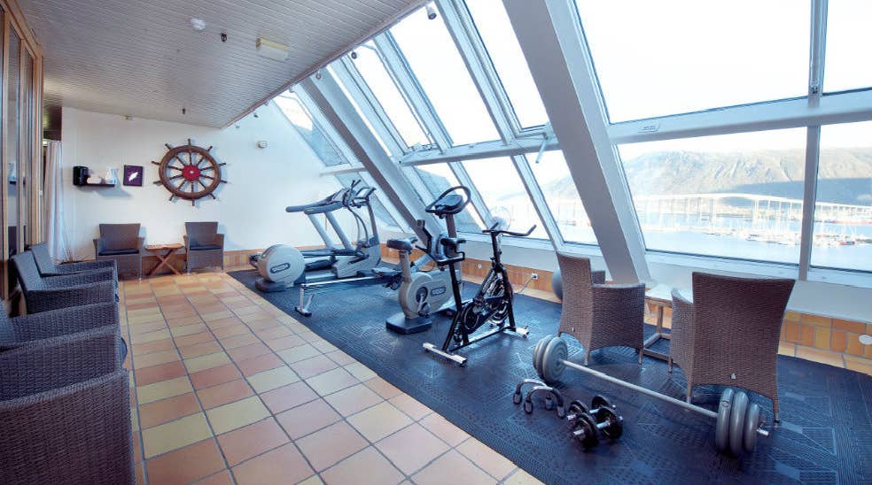Well-equipped gym with large windows and a great view at With Hotel in Tromso