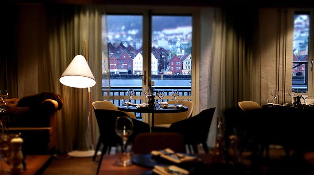 Cosy restaurant area with an astonishing view of the inlet and mountains at Admiral Hotel in Bergen