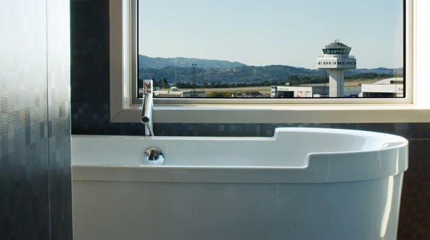 Enjoy the view of the airport from the bathtub in the suite at Bergen Airport Hotel in Bergen