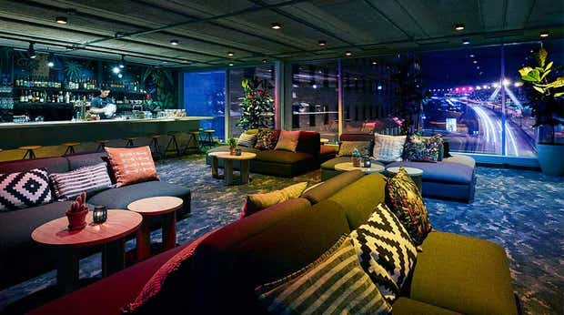 Interior view of sofas, cushions and the bartender at the Vatos bar at the Clarion Hotel Stockholm