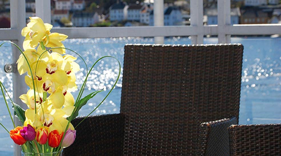 Relaxing terrace by the water outside the Kitchen & Table restaurant at Tyholmen Hotel in Arendal