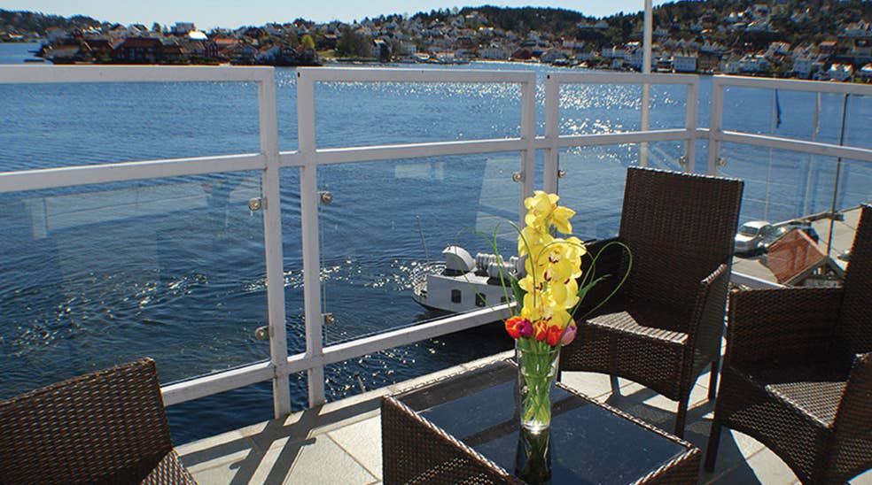 Sit directly by the waterfront on the terrace at Tyholmen Hotel in Arendal