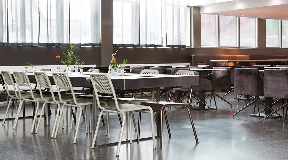 Lobby with community tables and metal chairs at Comfort Hotel Union Brygge in Drammen Norway