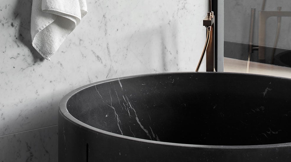 Round bath tub and marble tiles in the bathroom in the Masterpiece suite at the At Six hotel