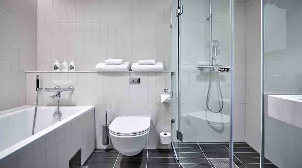 Tasteful bathroom with toilet, shower and bathtub at Nordic Light Hotel in Stockholm, Sweden