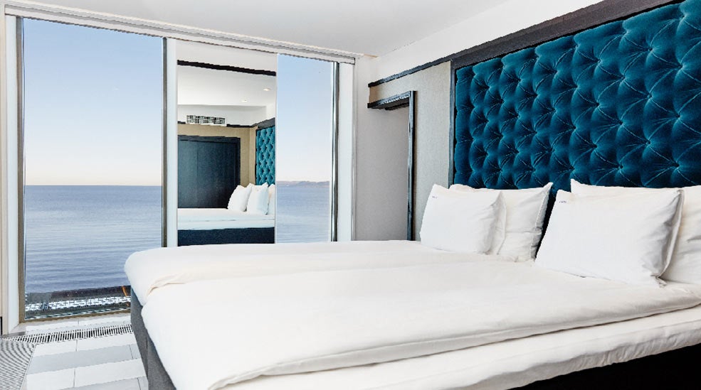 Vox Hotel's big suite, furnished with double bed in the bedroom with beautiful view over lake Vättern