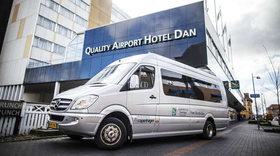 Airport shuttle bus and hotel façade at the Quality Airport Hotel Dan