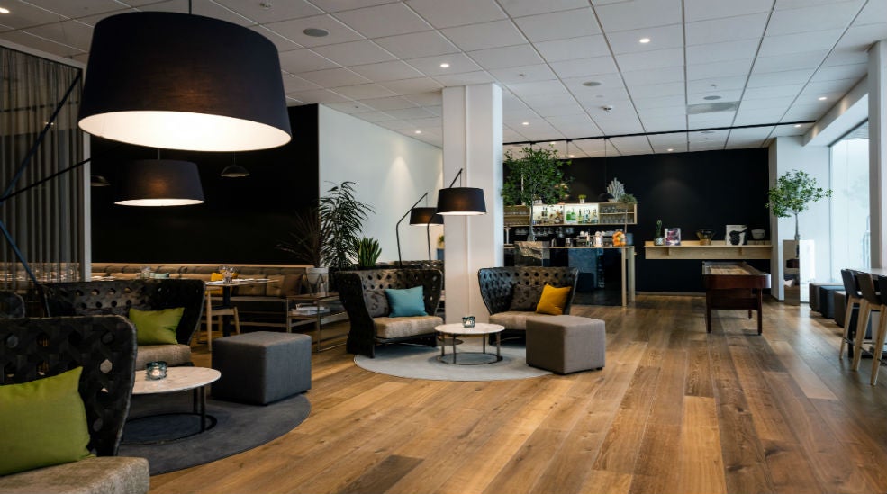 Lounge area with sofas, shuffelboard and bar at Quality Hotel Edvard Grieg Bergen