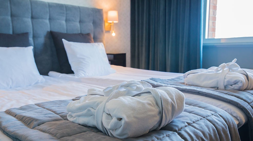 Bed and bathrobe in a Superior double room at Quality Hotel Galaxen in Borlänge