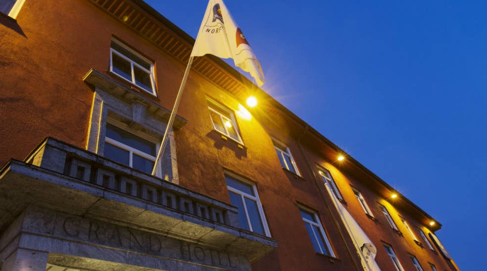 Flag with the hotel logo hanging over the entrance of the Quality Grand Hotel in Kristiansund
